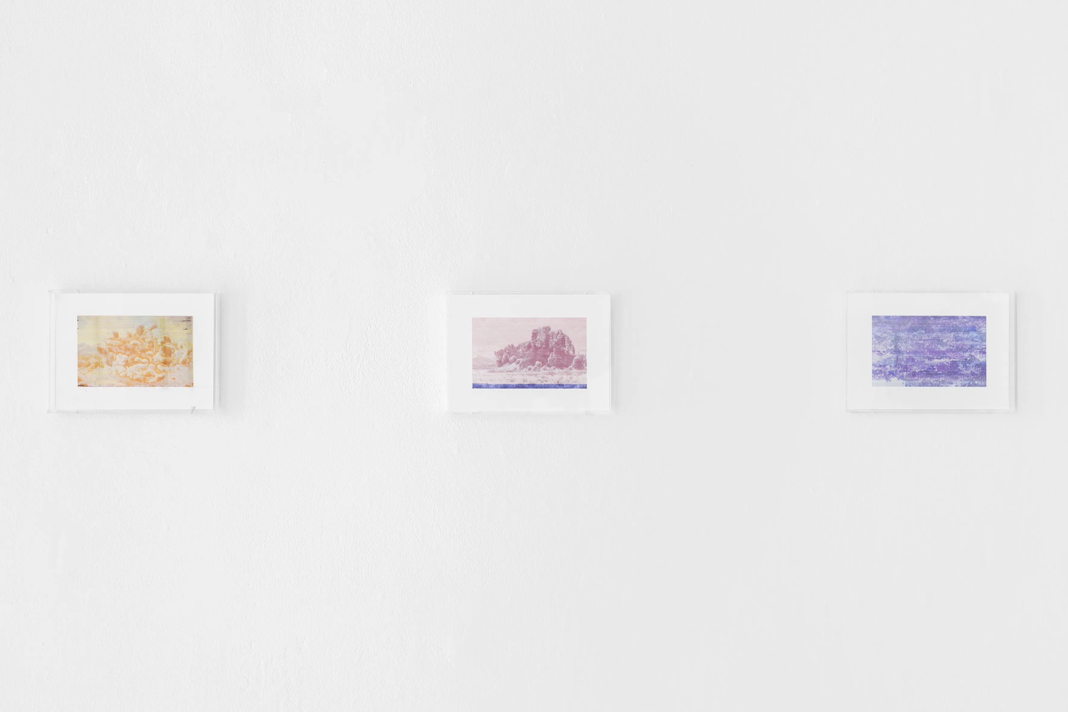 View of the AI-generated faces engraved with laser cutter on colored marble